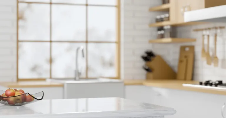 Bright kitchen with a light marble-look countertop, farmhouse sink, and wood accents.