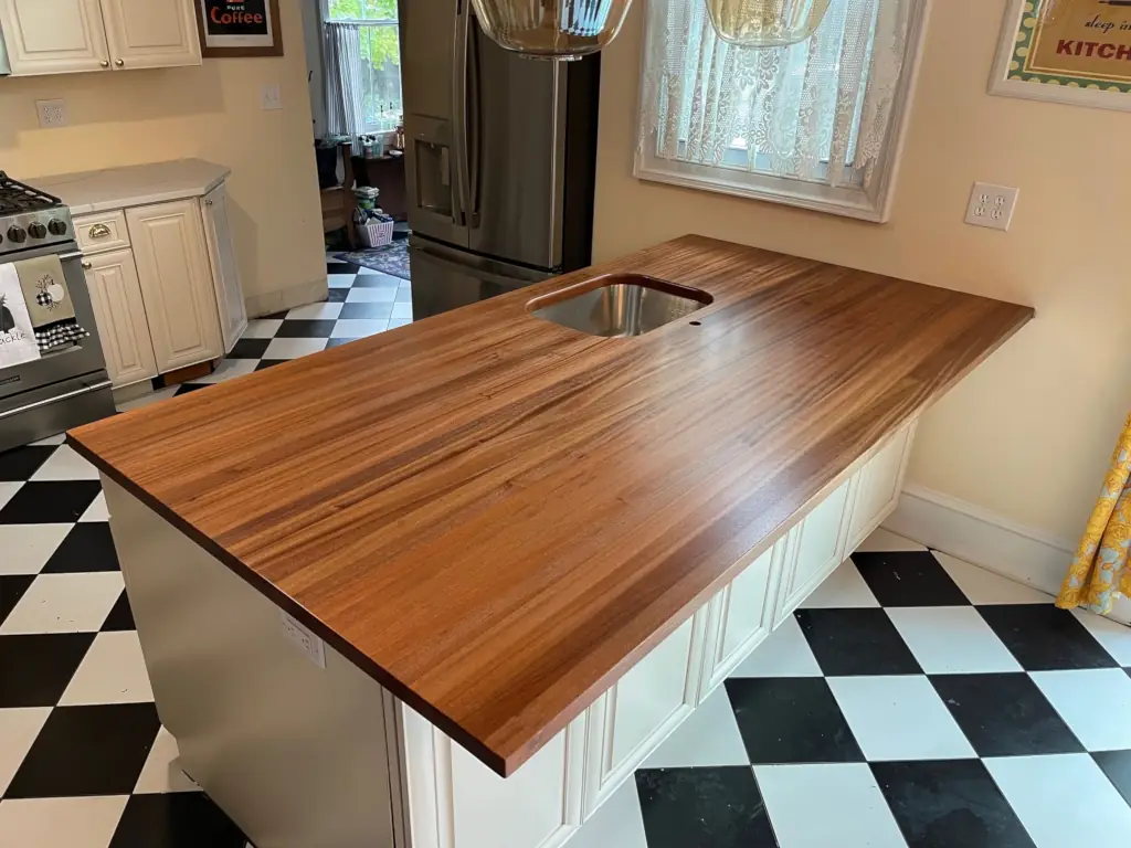 Custom wood countertop with an integrated stainless steel sink on a kitchen island.